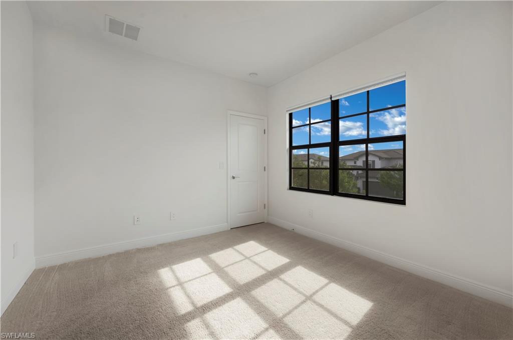 7549 Carnegie Way Naples, FL 34119 - Photo 10 of 22 an empty room with windows