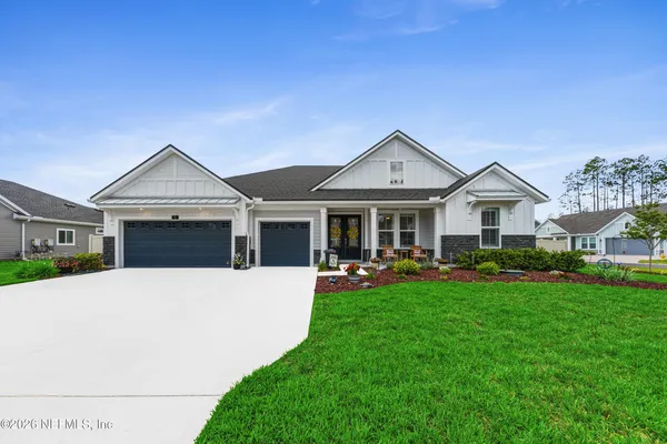 a front view of a house with patio and garden