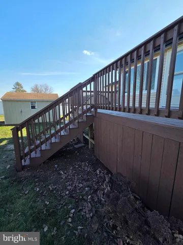 a view of a backyard with a small deck