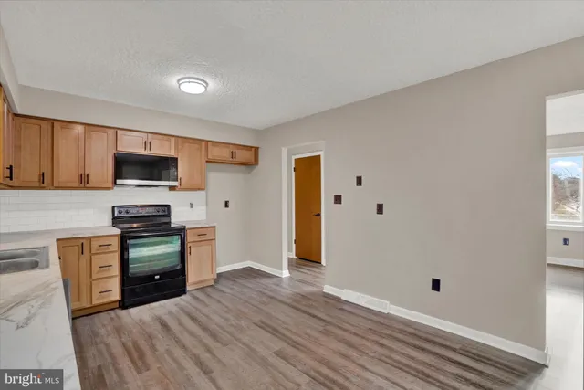 a kitchen with stainless steel appliances granite countertop a stove and a refrigerator