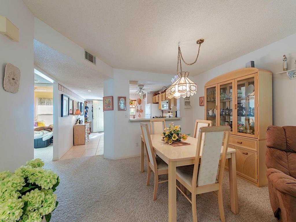 653 Squire Circle, Unit 102 Naples, FL 34104 - Photo 3 of 17 a view of a dining room with furniture