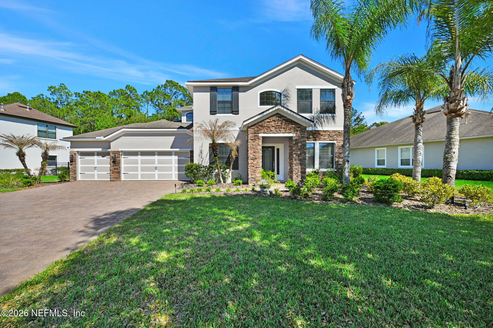 212 North Arabella Way St. Johns, FL 32259 - Photo 2 of 83 a front view of a house with a garden