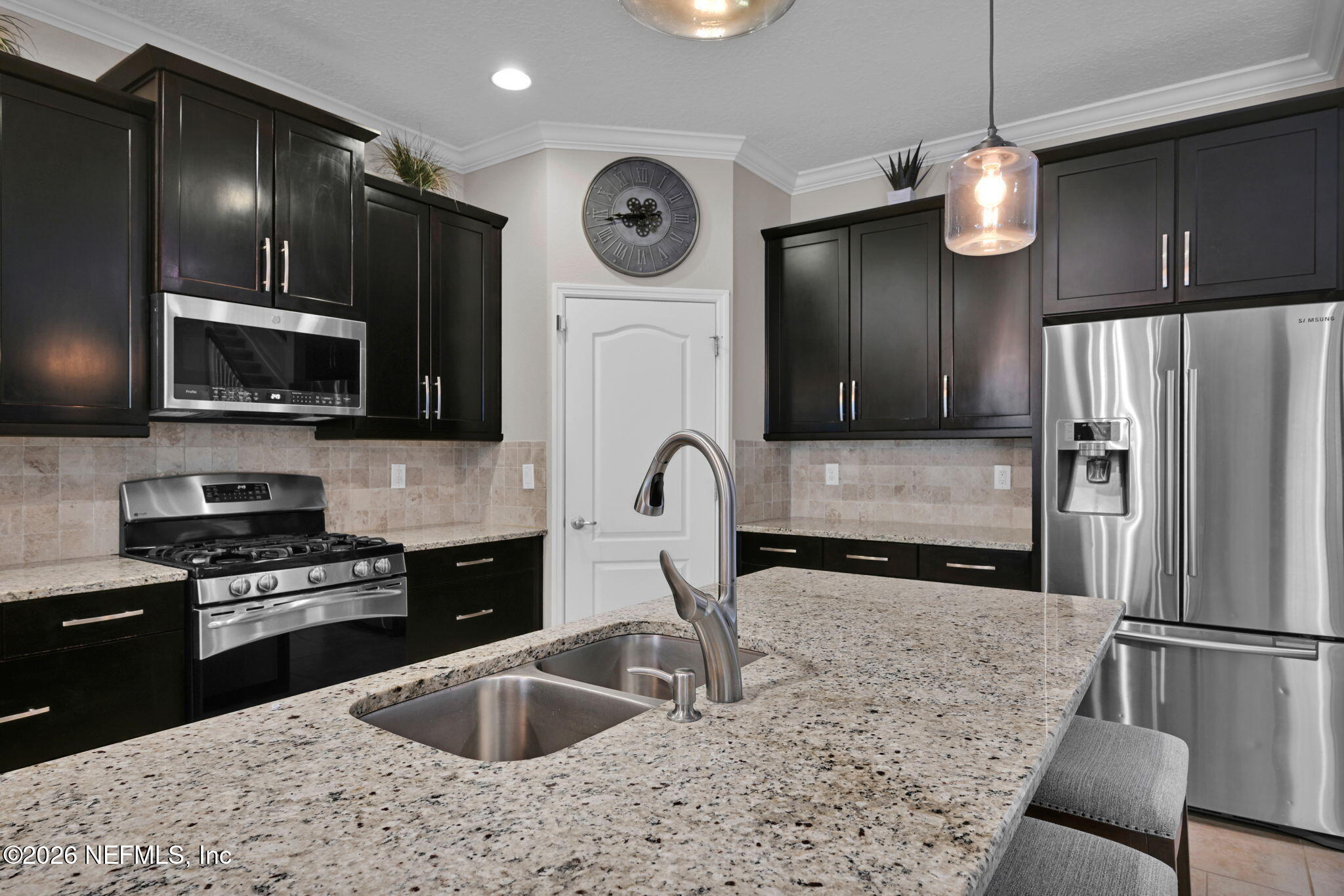 212 North Arabella Way St. Johns, FL 32259 - Photo 21 of 83 a kitchen with stainless steel appliances granite countertop a sink refrigerator and microwave
