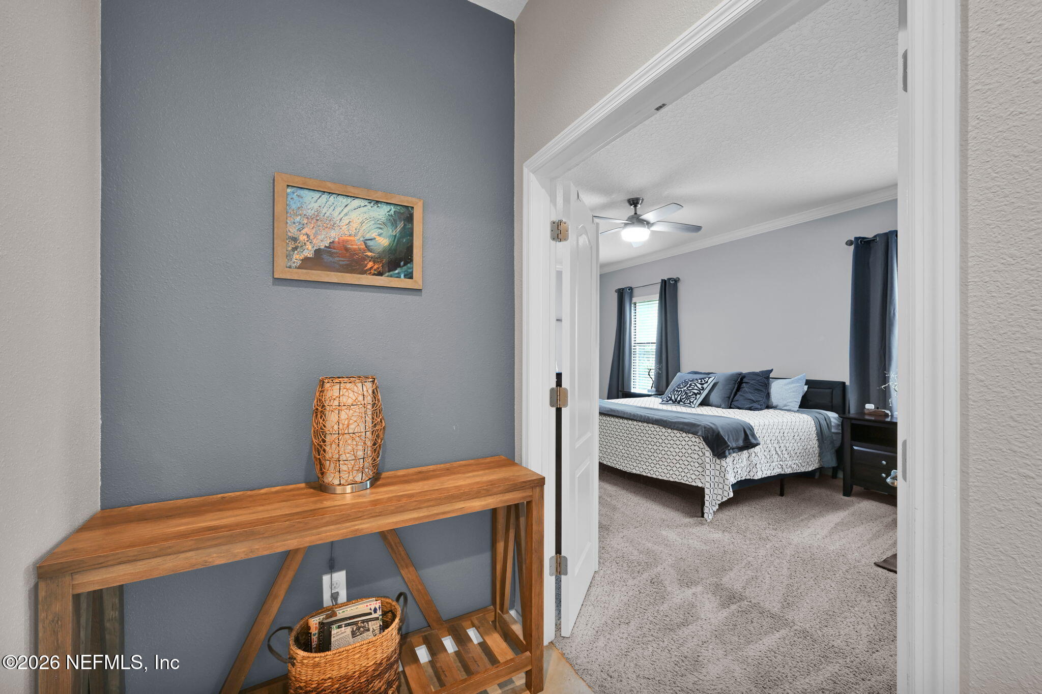 212 North Arabella Way St. Johns, FL 32259 - Photo 28 of 83 a bedroom with a bed and a chandelier