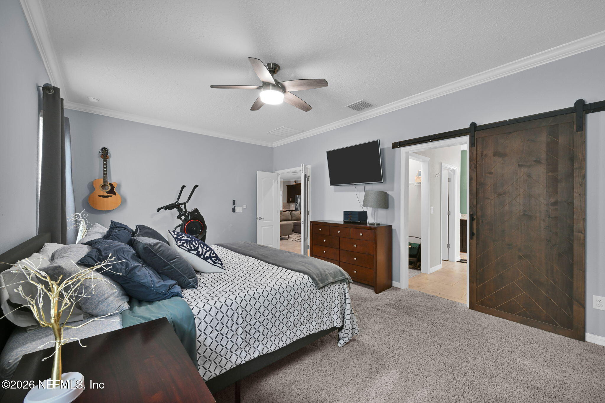 212 North Arabella Way St. Johns, FL 32259 - Photo 31 of 83 a bedroom with a bed and a flat tv screen