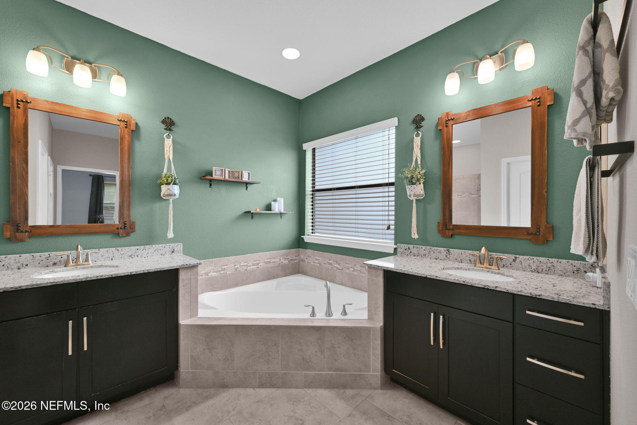 212 North Arabella Way St. Johns, FL 32259 - Photo 32 of 83 a bathroom with a granite countertop bathtub sink vanity and mirror