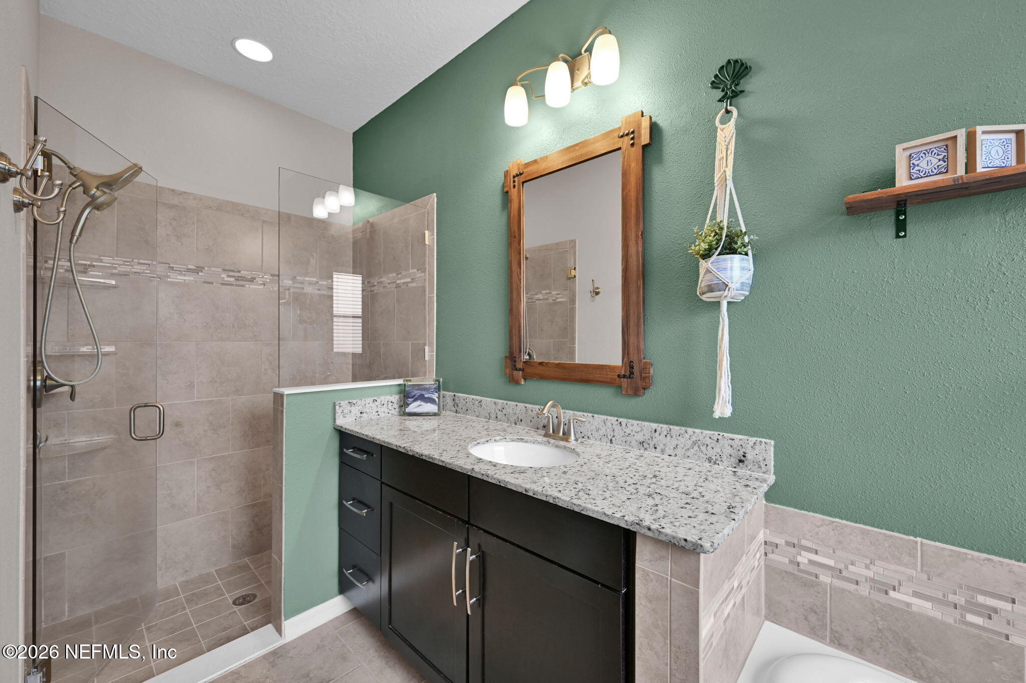 212 North Arabella Way St. Johns, FL 32259 - Photo 33 of 83 a bathroom with a granite countertop sink a mirror and a shower