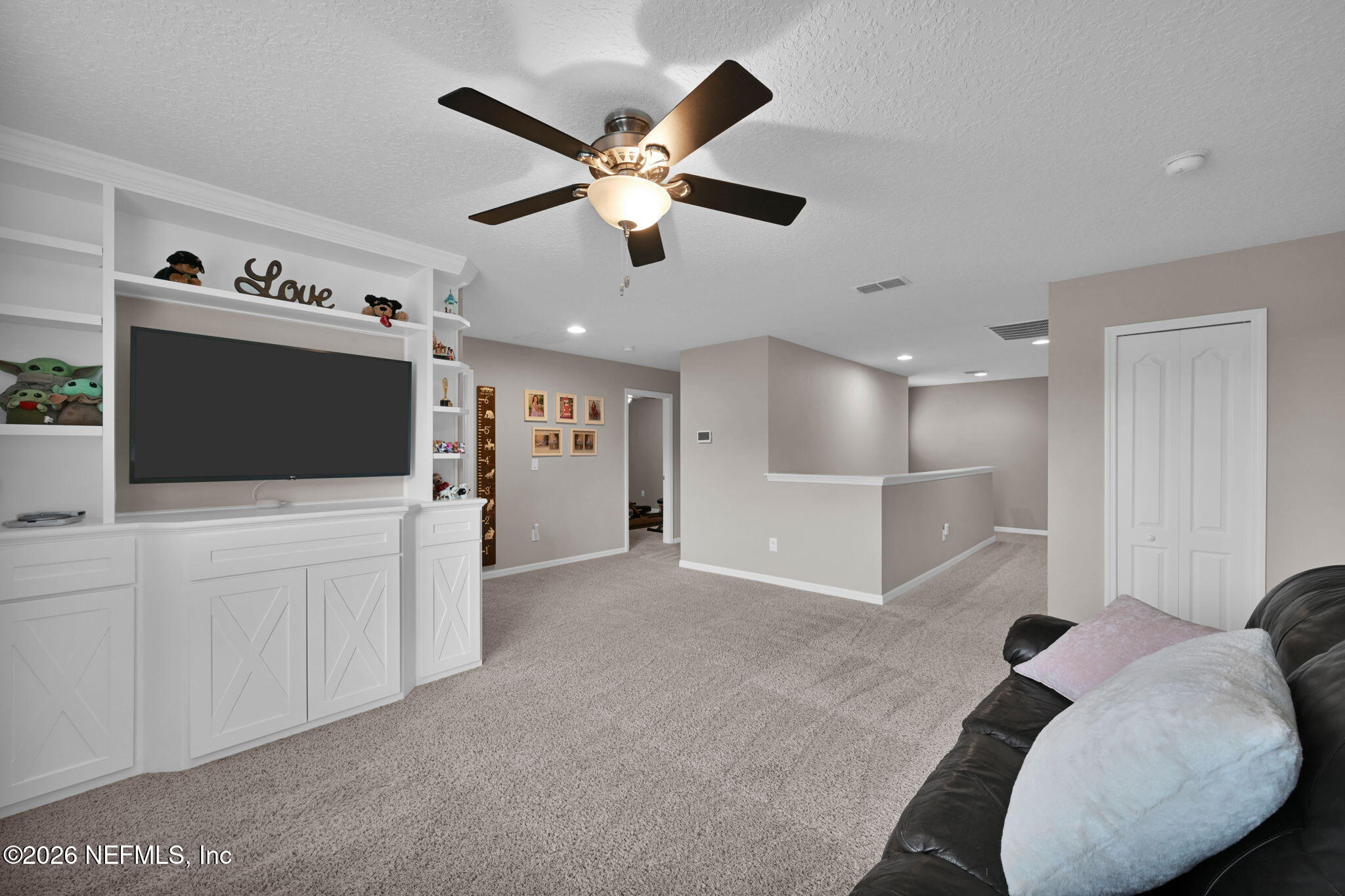 212 North Arabella Way St. Johns, FL 32259 - Photo 36 of 83 a living room with furniture and a flat screen tv