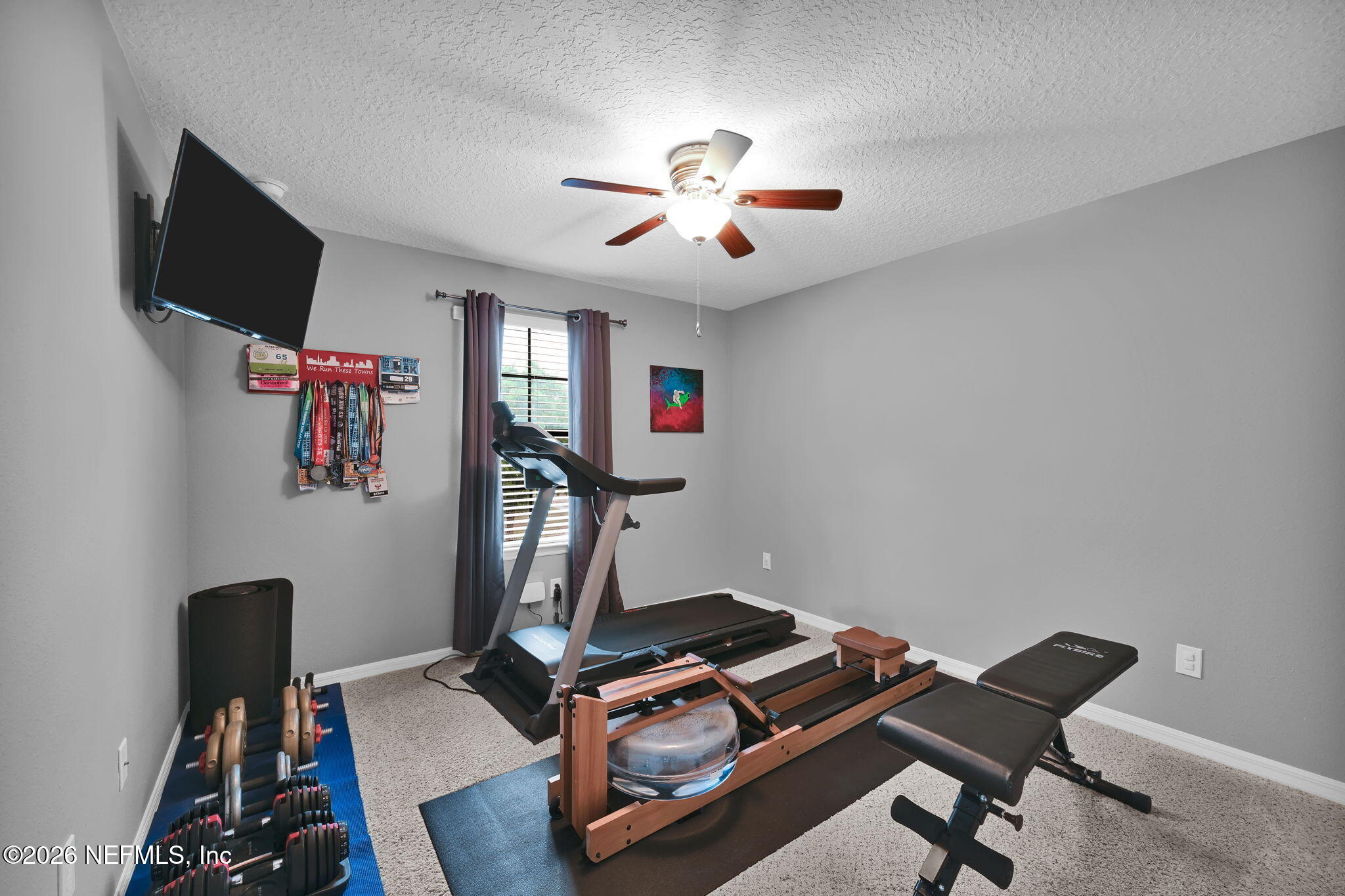 212 North Arabella Way St. Johns, FL 32259 - Photo 38 of 83 a room with gym equipment and a flat screen tv