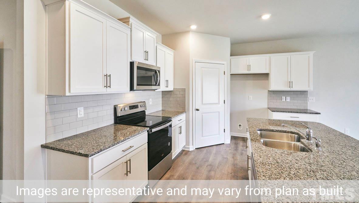 608 Rex Court Carthage, NC 28327 - Photo 11 of 22 a kitchen with a stove a sink and a microwave
