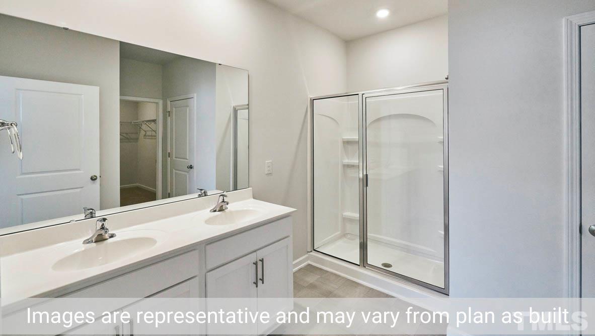 608 Rex Court Carthage, NC 28327 - Photo 19 of 22 a bathroom with a sink mirror and shower