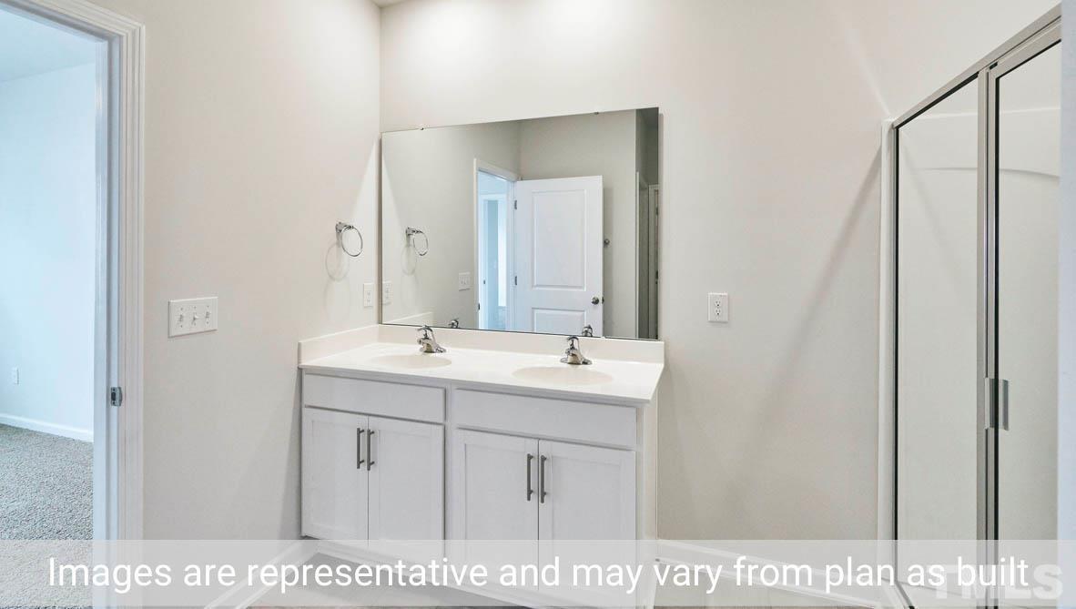 608 Rex Court Carthage, NC 28327 - Photo 22 of 22 a bathroom with a sink a vanity and a mirror