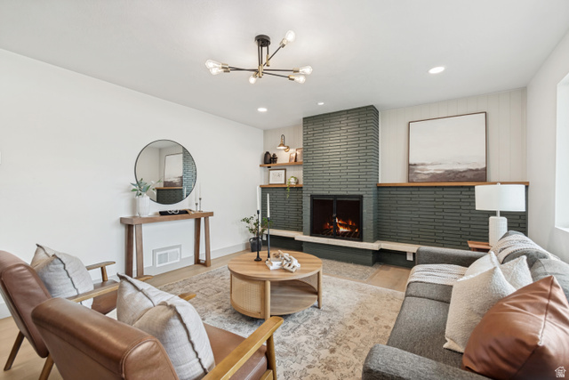 1010 West Maple Street Mapleton, UT 84664 - Photo 17 of 24 Living area featuring a floor-to-ceiling brick fireplace with a wood mantel, recessed lighting, and wood-finish flooring