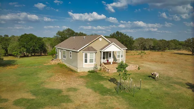 a porch with chairs and garden