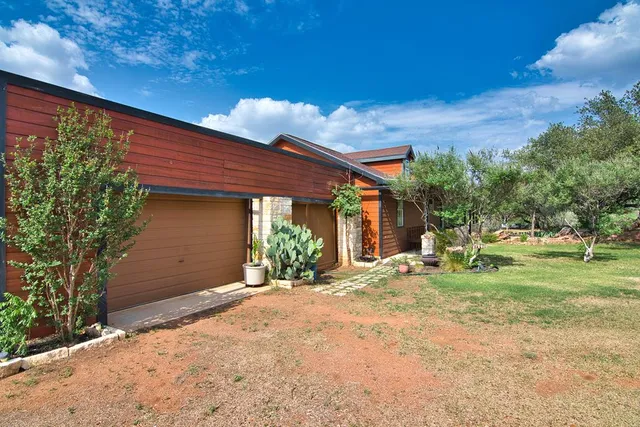 a kitchen with kitchen island a counter top space appliances and a dining table