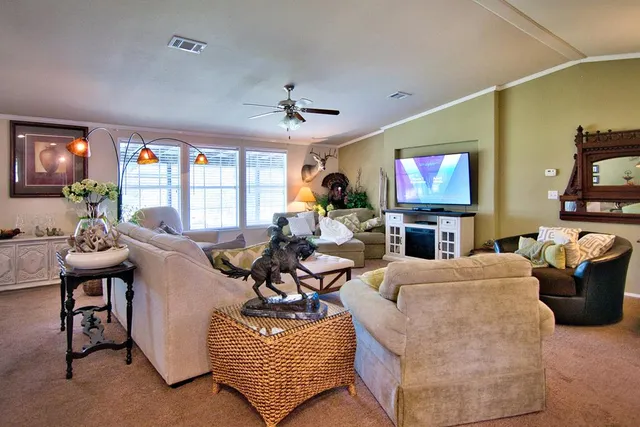 a large bed sitting in a bedroom next to a window and a lamp
