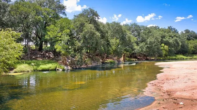 a front view of a house with garden and patio