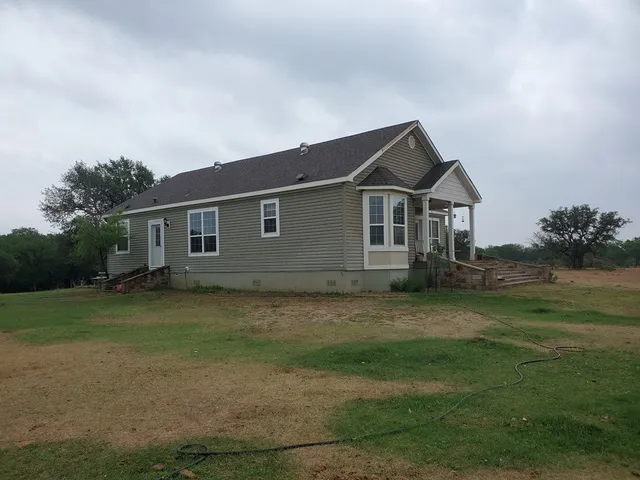 a view of a lake with beach and outdoor space
