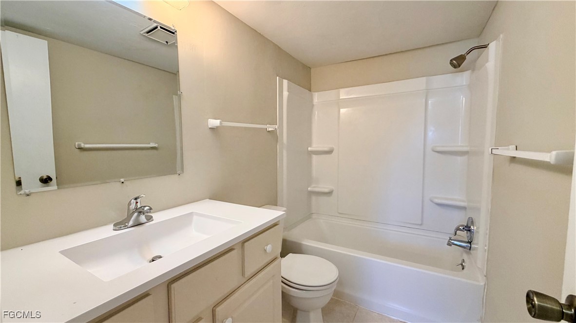 8049 Country Road, Unit 101 Fort Myers, FL 33919 - Photo 12 of 19 a bathroom with a sink mirror toilet and bathtub