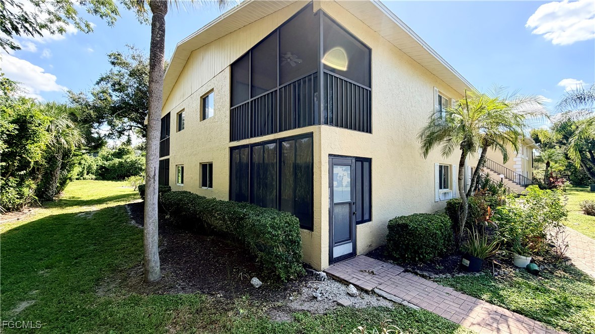 8049 Country Road, Unit 101 Fort Myers, FL 33919 - Photo 19 of 19 a view of a house with a yard