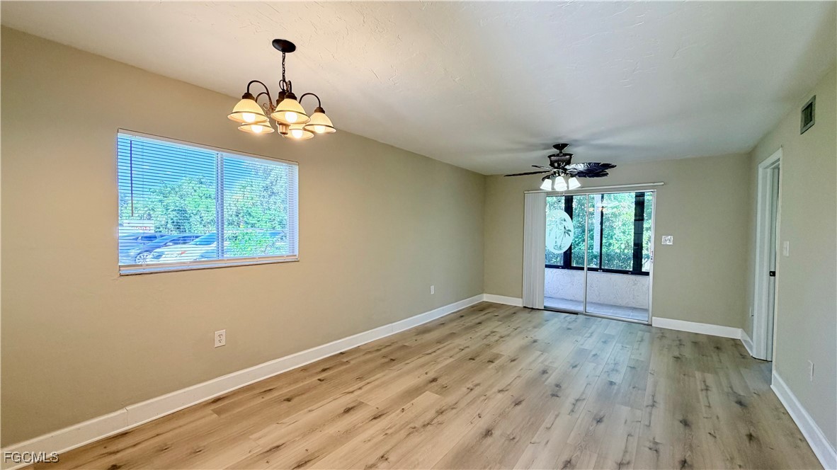 8049 Country Road, Unit 101 Fort Myers, FL 33919 - Photo 3 of 19 wooden floor in an empty room with a window