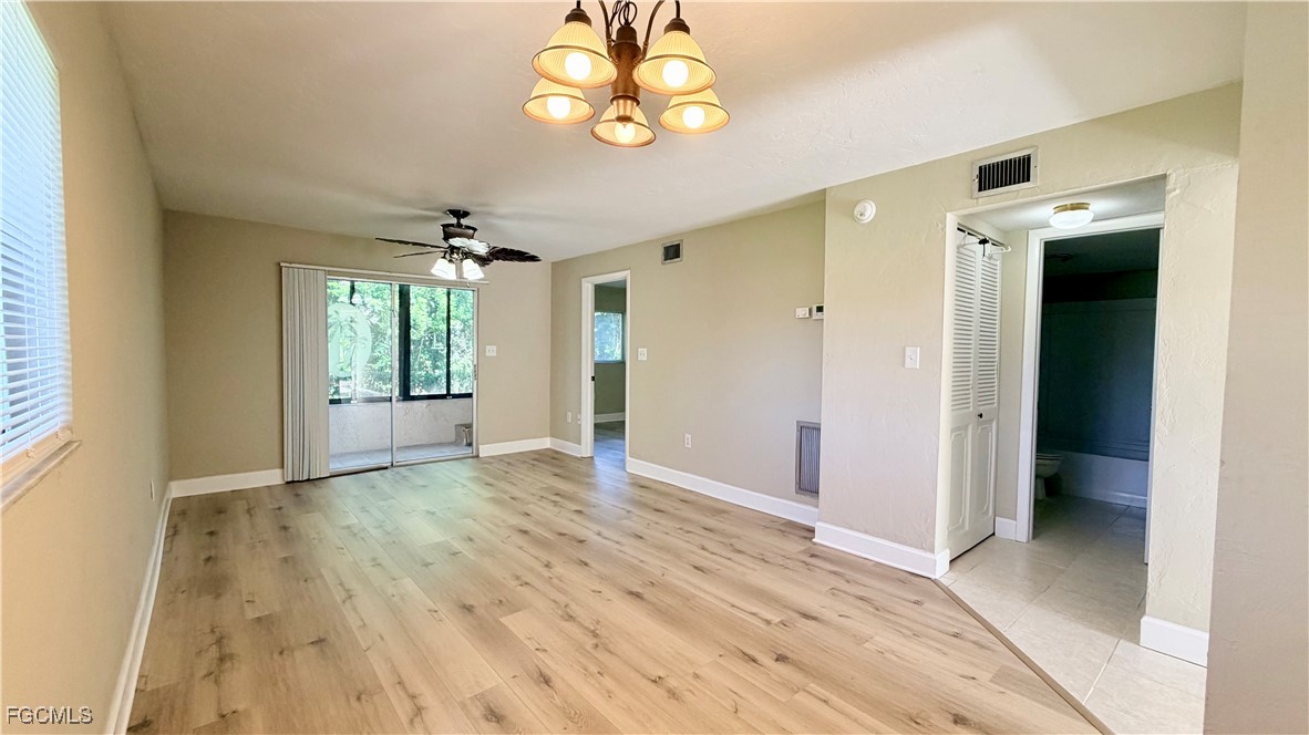 8049 Country Road, Unit 101 Fort Myers, FL 33919 - Photo 4 of 19 wooden floor in an empty room with a window
