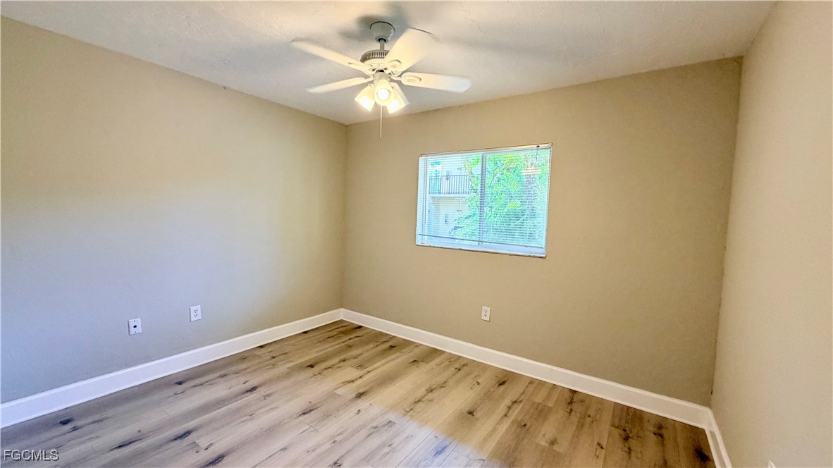 8049 Country Road, Unit 101 Fort Myers, FL 33919 - Photo 10 of 19 wooden floor in an empty room