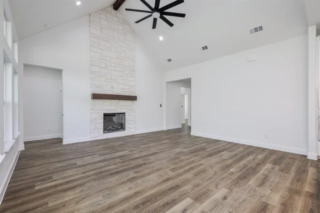 wooden floor in an empty room with a fireplace