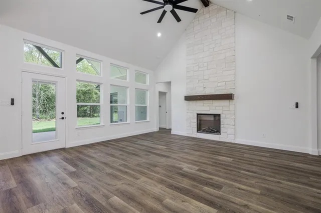 a view of an empty room with glass door and balcony