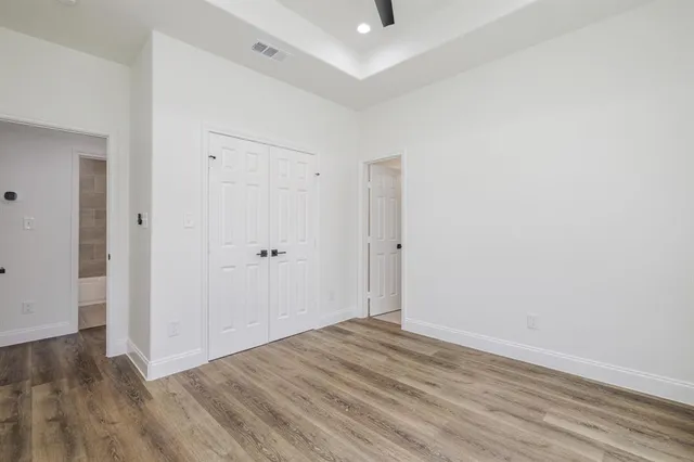 a view of a room with wooden floor
