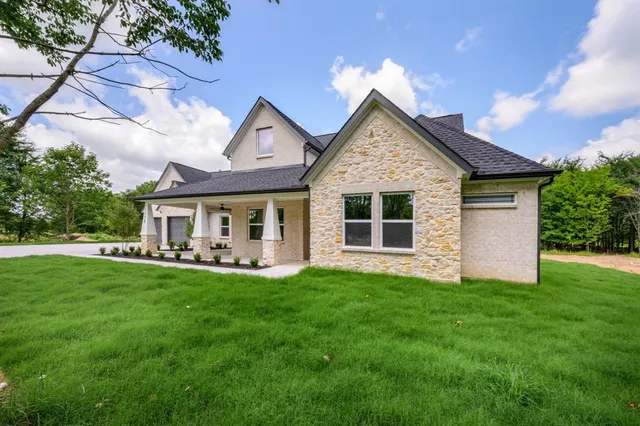 a front view of house with yard and green space