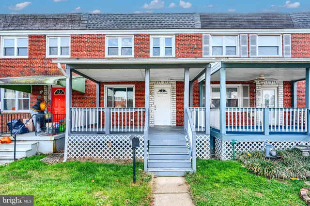 front view of a brick house with a small garden