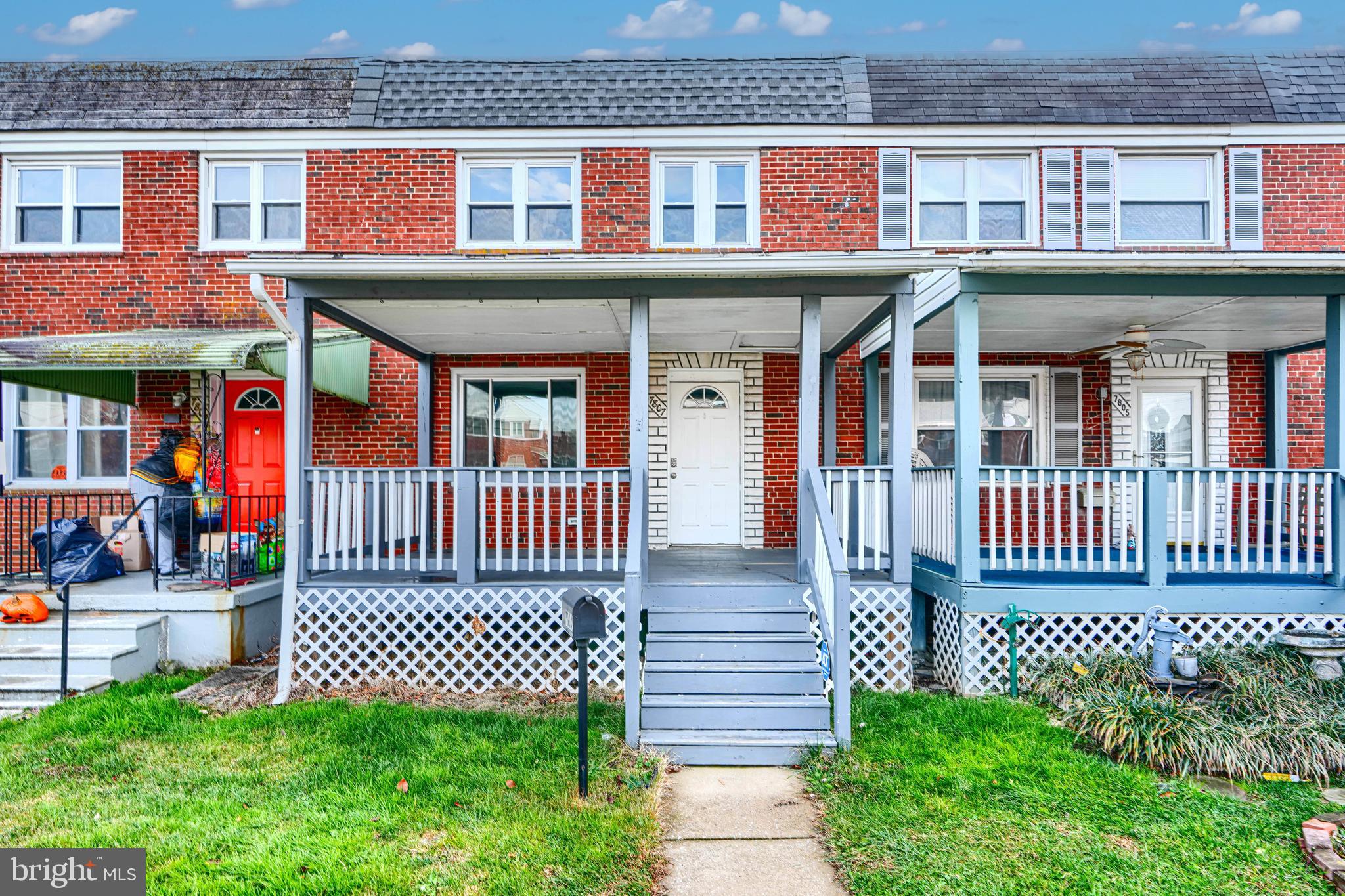 front view of a brick house with a small garden