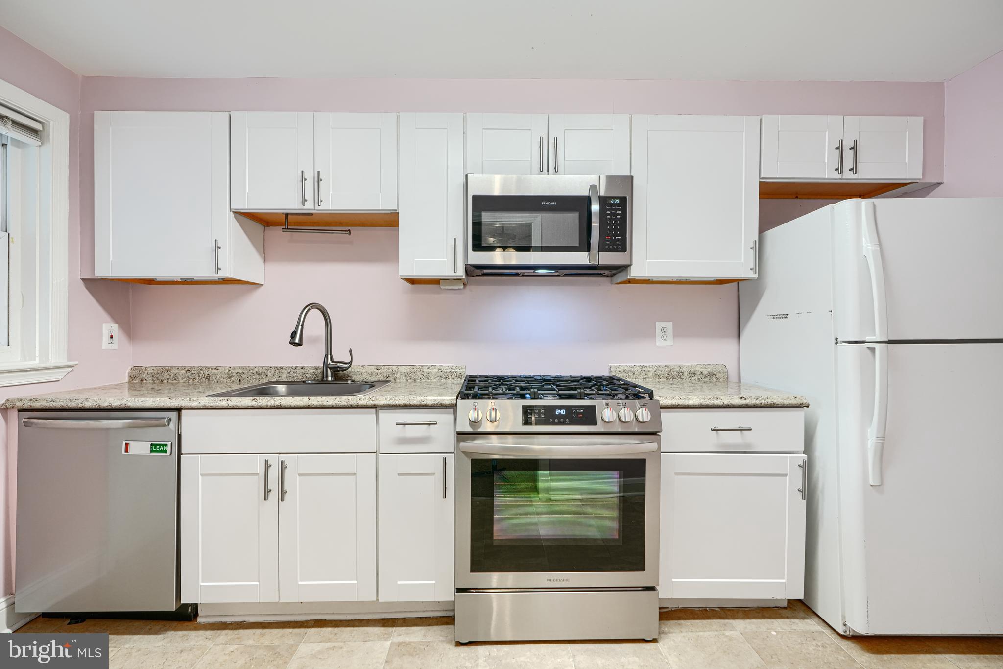 7807 Rockbourne Road Dundalk, MD 21222 - Photo 11 of 31 a kitchen with cabinets stainless steel appliances and a sink
