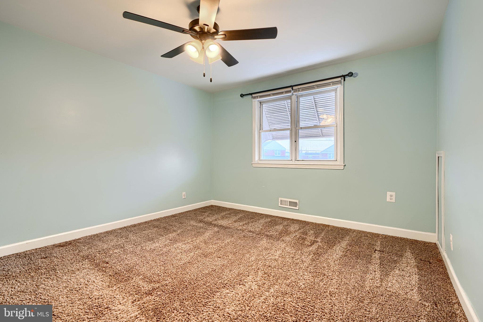 7807 Rockbourne Road Dundalk, MD 21222 - Photo 15 of 31 an empty room with a window and a fan