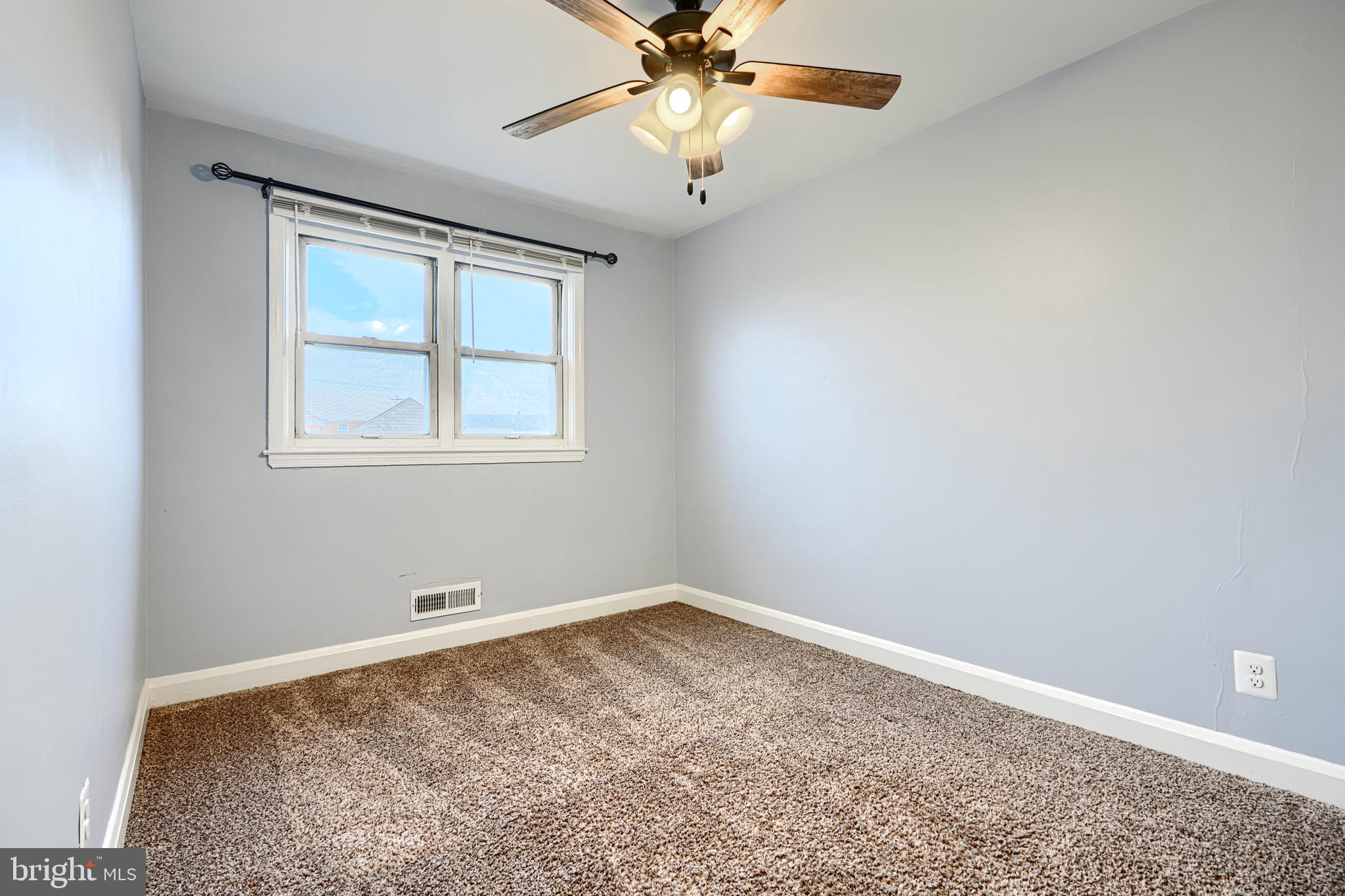 7807 Rockbourne Road Dundalk, MD 21222 - Photo 22 of 31 an empty room with windows and fan