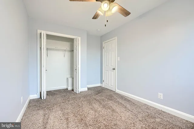 an empty room with a ceiling fan
