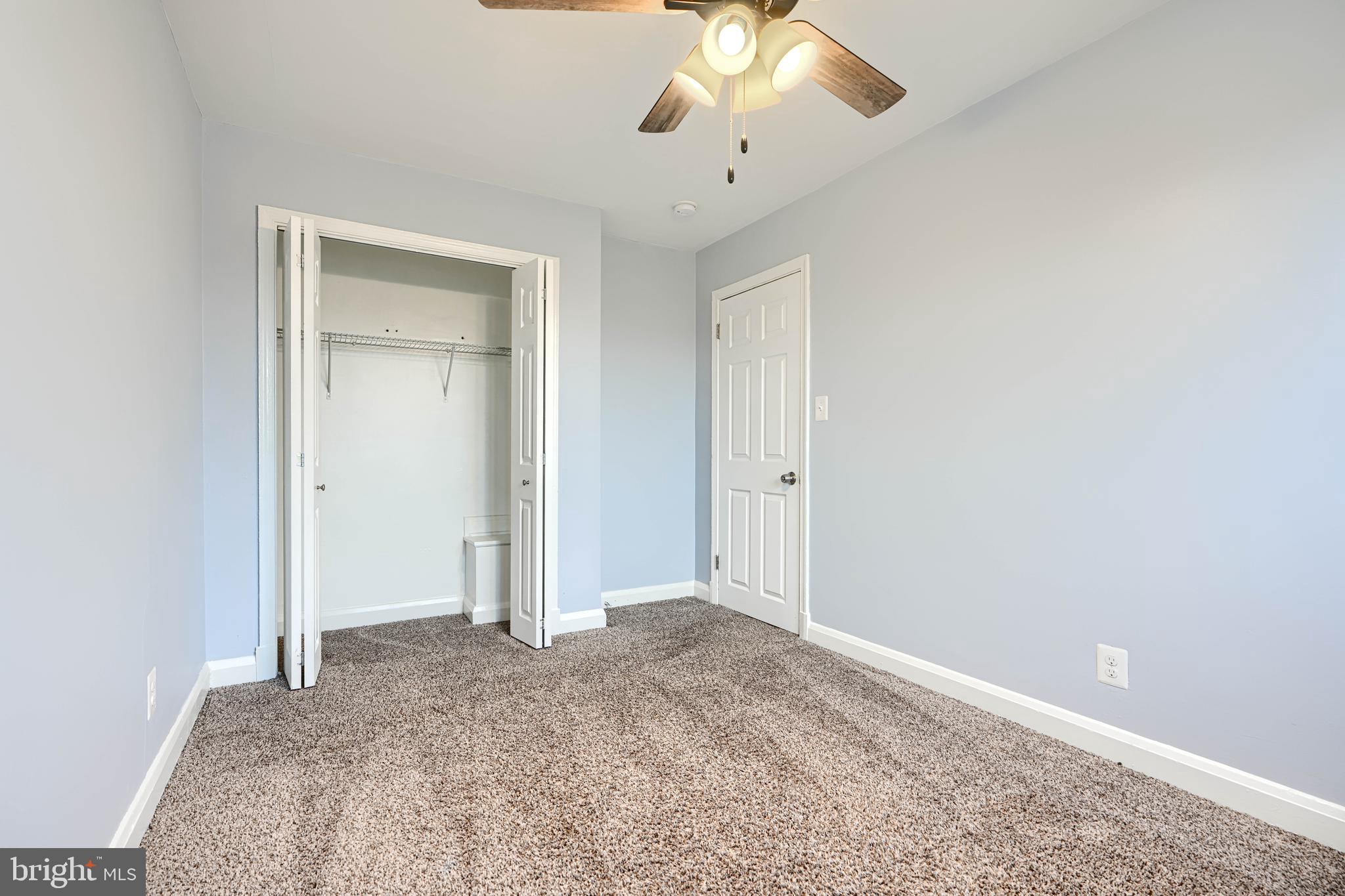 7807 Rockbourne Road Dundalk, MD 21222 - Photo 24 of 31 an empty room with a ceiling fan