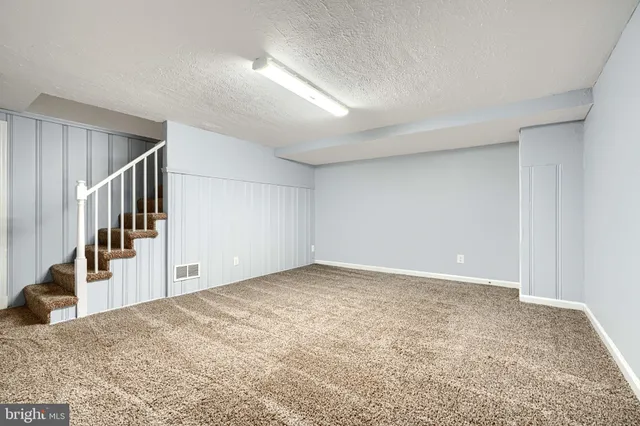 a view of an empty room and stairs