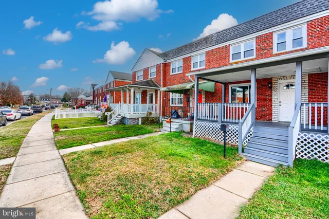 a front view of a house with a yard table and chairs