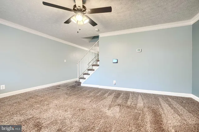 an empty room with fan and a ceiling fan