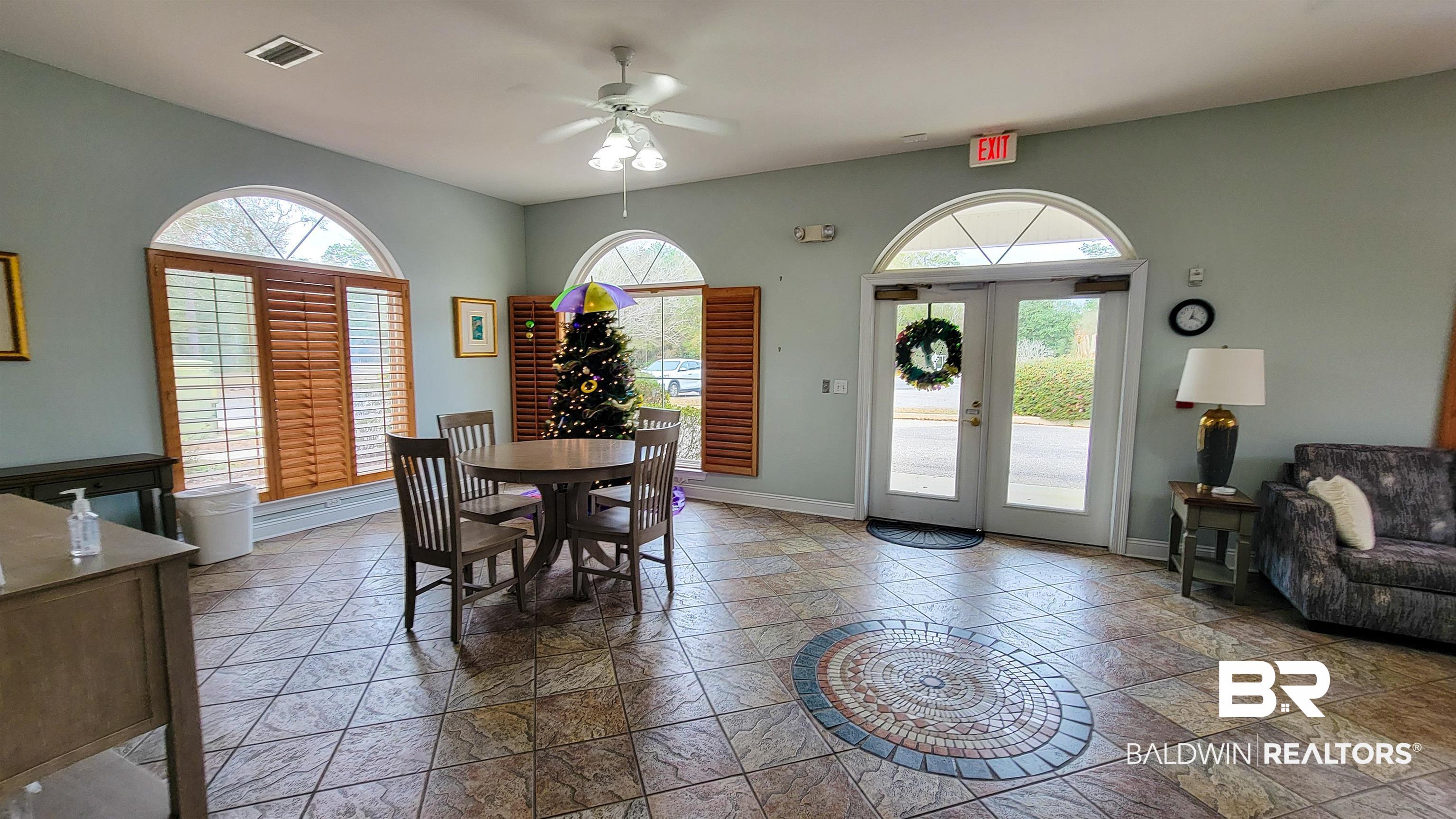 214 Hemingway Loop Foley, AL 36535 - Photo 63 of 67 Dining area with french doors, ceiling fan, and stone tile flooring