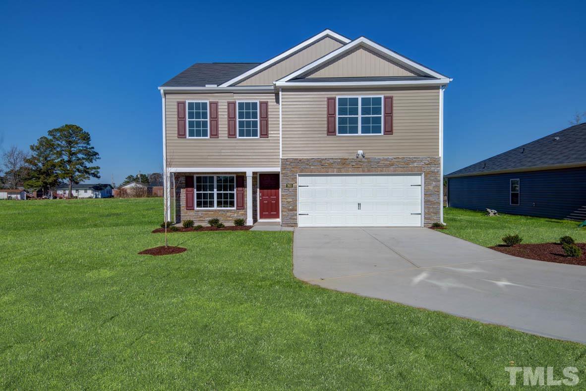 7621 Sand Pit Road Stantonsburg, NC 27883 - Photo 2 of 58 a front view of a house with a yard and garage