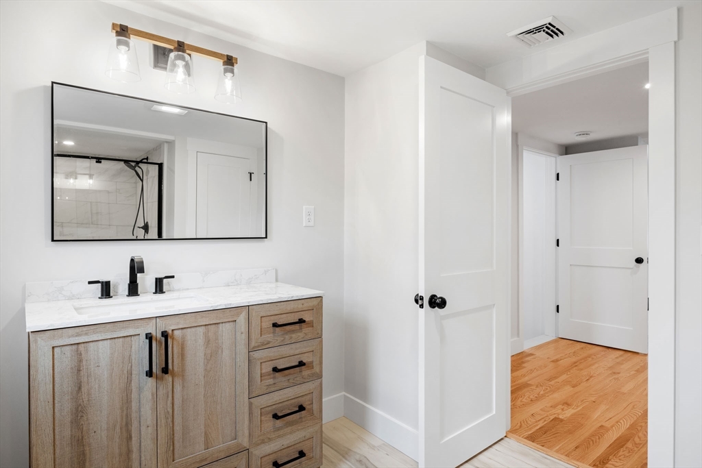 18 Martin Street Wareham, MA 02532 - Photo 20 of 42 a bathroom with a sink vanity and mirror