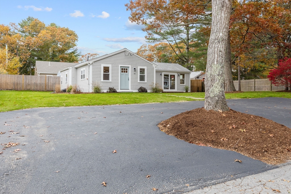 18 Martin Street Wareham, MA 02532 - Photo 5 of 42 a front view of a house with a yard and garage