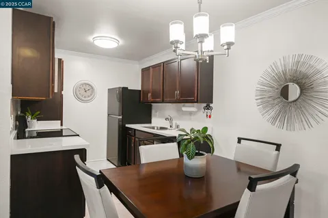 a dining room with furniture a window and wooden floor