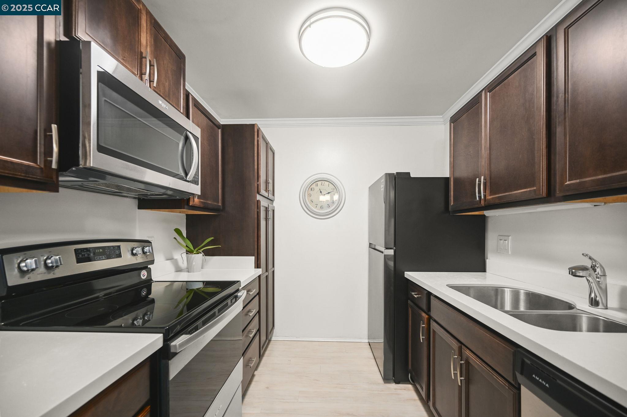 1411 Marchbanks Drive, Unit 2 Walnut Creek, CA 94598 - Photo 12 of 42 a kitchen with stainless steel appliances granite countertop a refrigerator stove and sink