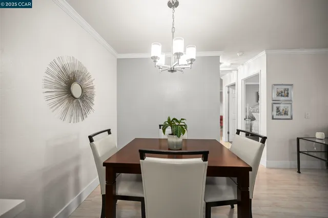 a dining room with furniture and chandelier