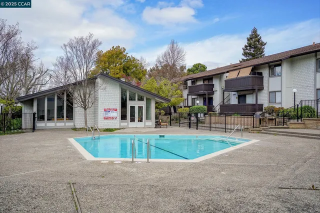 a view of a house with swimming pool and sitting area