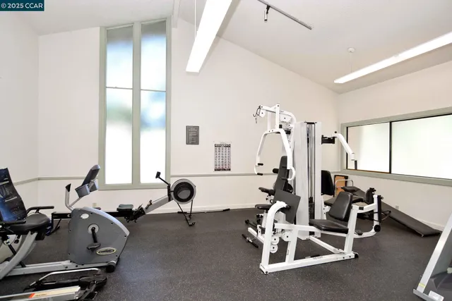 a room with gym equipment and a large window